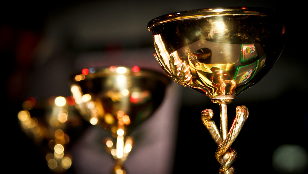 Cannabis Cup in Los Angeles: Ultimate Guide 2022: Three shiny gilded marijuana trophies